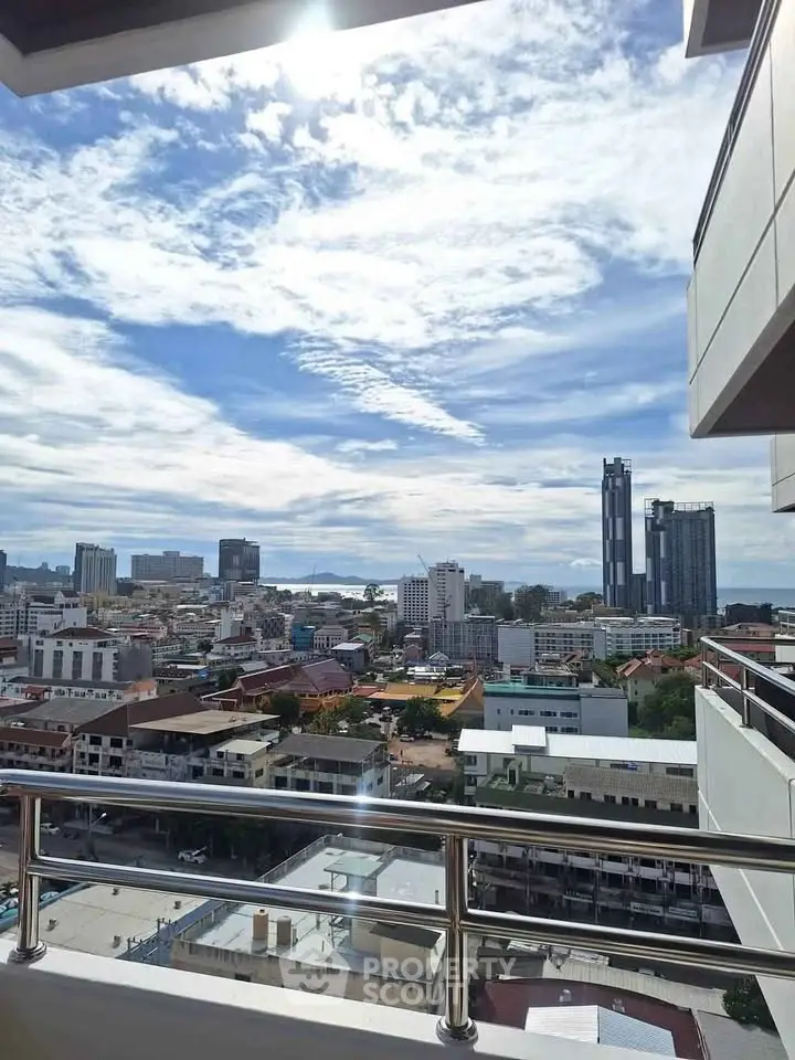 Stunning cityscape view from a high-rise balcony with modern skyline and blue skies.