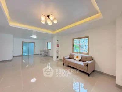 Spacious living room with modern lighting and cozy sofa in elegant apartment.