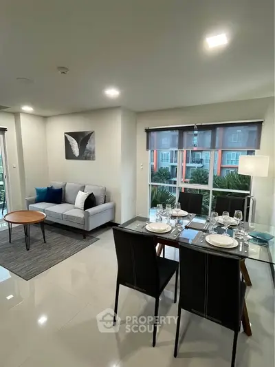 Modern living room with elegant dining area and large windows