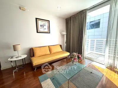 Modern living room with stylish decor and balcony access, featuring a cozy sofa and elegant glass coffee table.