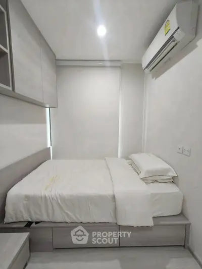 Modern minimalist bedroom with sleek design and air conditioning