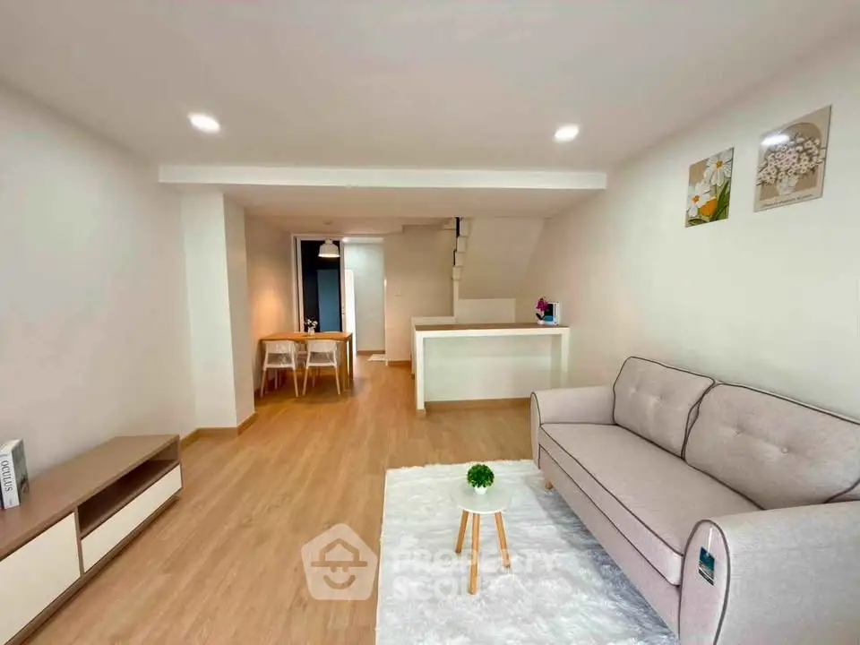 Modern living room with cozy sofa and stylish decor in open layout apartment.