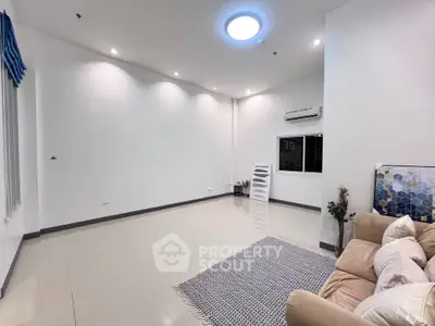 Spacious modern living room with sleek design and cozy seating area.