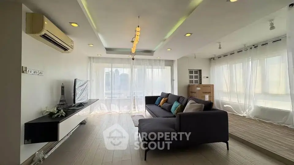 Spacious modern living room with large windows and stylish decor