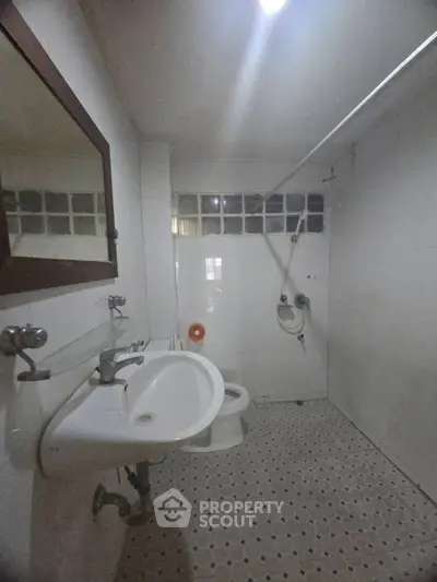 Spacious bathroom with modern fixtures and tiled flooring