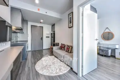 Modern open-plan living room with stylish decor and sleek kitchen area