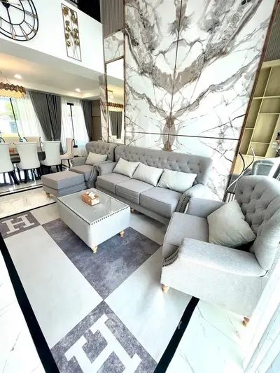 Luxurious living room with elegant gray furniture and marble accents, perfect for modern living.