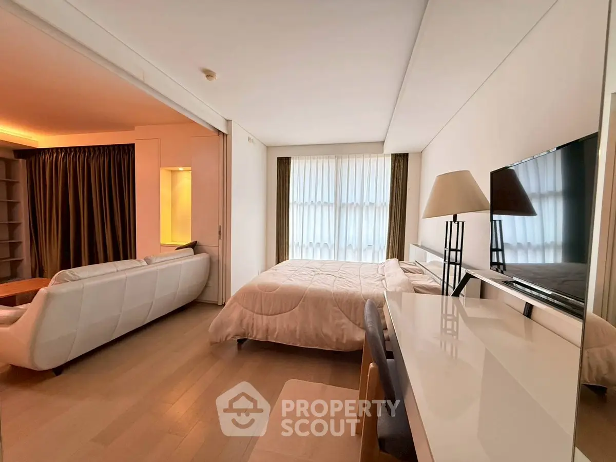 Spacious modern bedroom with elegant decor and natural light