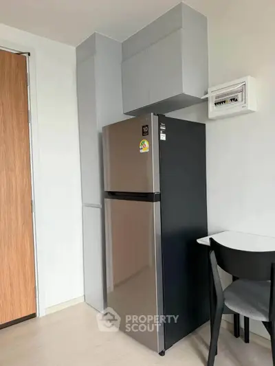 Modern kitchen corner with sleek fridge and minimalist design