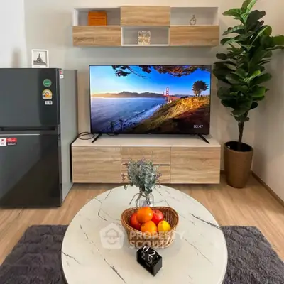 Modern living room with stylish decor, featuring a flat-screen TV, sleek furniture, and a cozy ambiance.