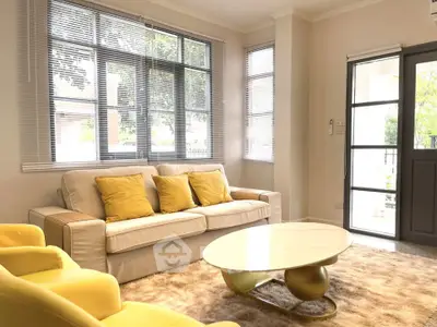 Bright and cozy living room with modern furniture and large windows