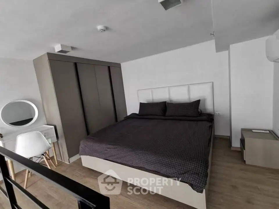 Modern bedroom with sleek design, featuring a large bed, built-in wardrobe, and stylish vanity area.