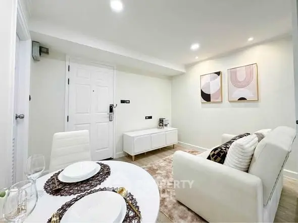 Modern living room with stylish decor and dining area in a cozy apartment.