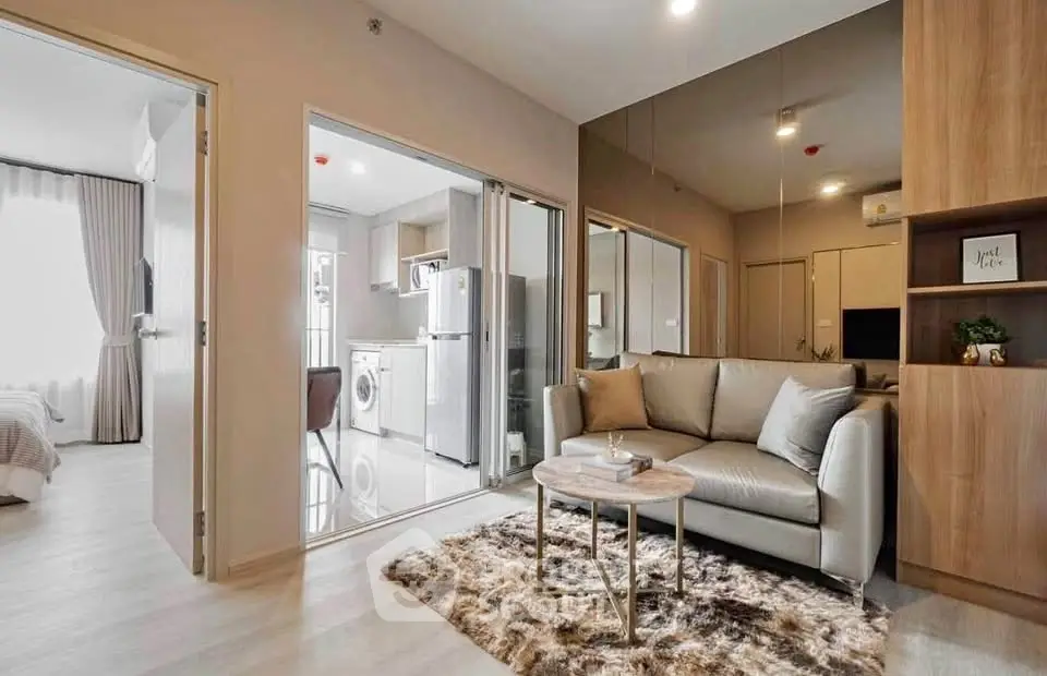 Modern living room with cozy sofa and open kitchen in stylish apartment