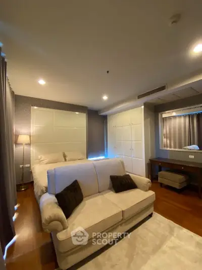 Luxurious bedroom with elegant decor and cozy seating area, perfect for relaxation.