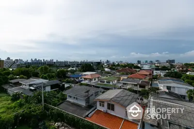 Scenic aerial view of suburban neighborhood with diverse rooftops and lush greenery.