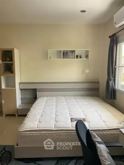 Spacious bedroom with modern furniture and natural light