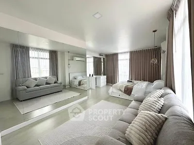 Spacious modern living room with large mirror and cozy seating area