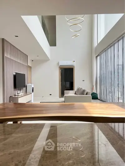 Luxurious modern living room with high ceilings and elegant decor