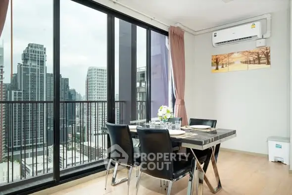 Modern dining area with city view and large windows in a high-rise apartment.