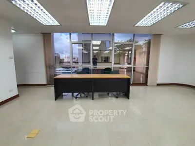 Spacious office space with large windows and ample natural light