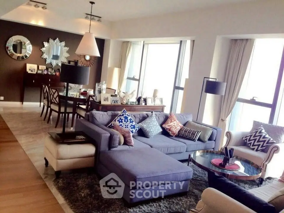 Spacious living room with modern decor and large windows offering natural light.