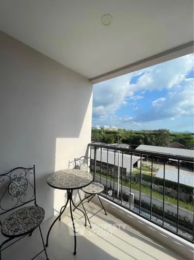 Charming balcony with scenic view, perfect for relaxation and outdoor dining.