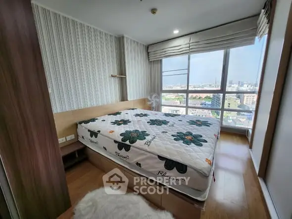 Modern bedroom with large window offering city view and stylish decor.