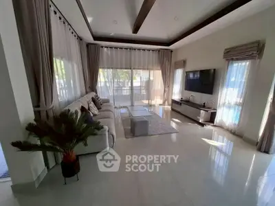 Spacious living room with elegant decor and large windows offering natural light.