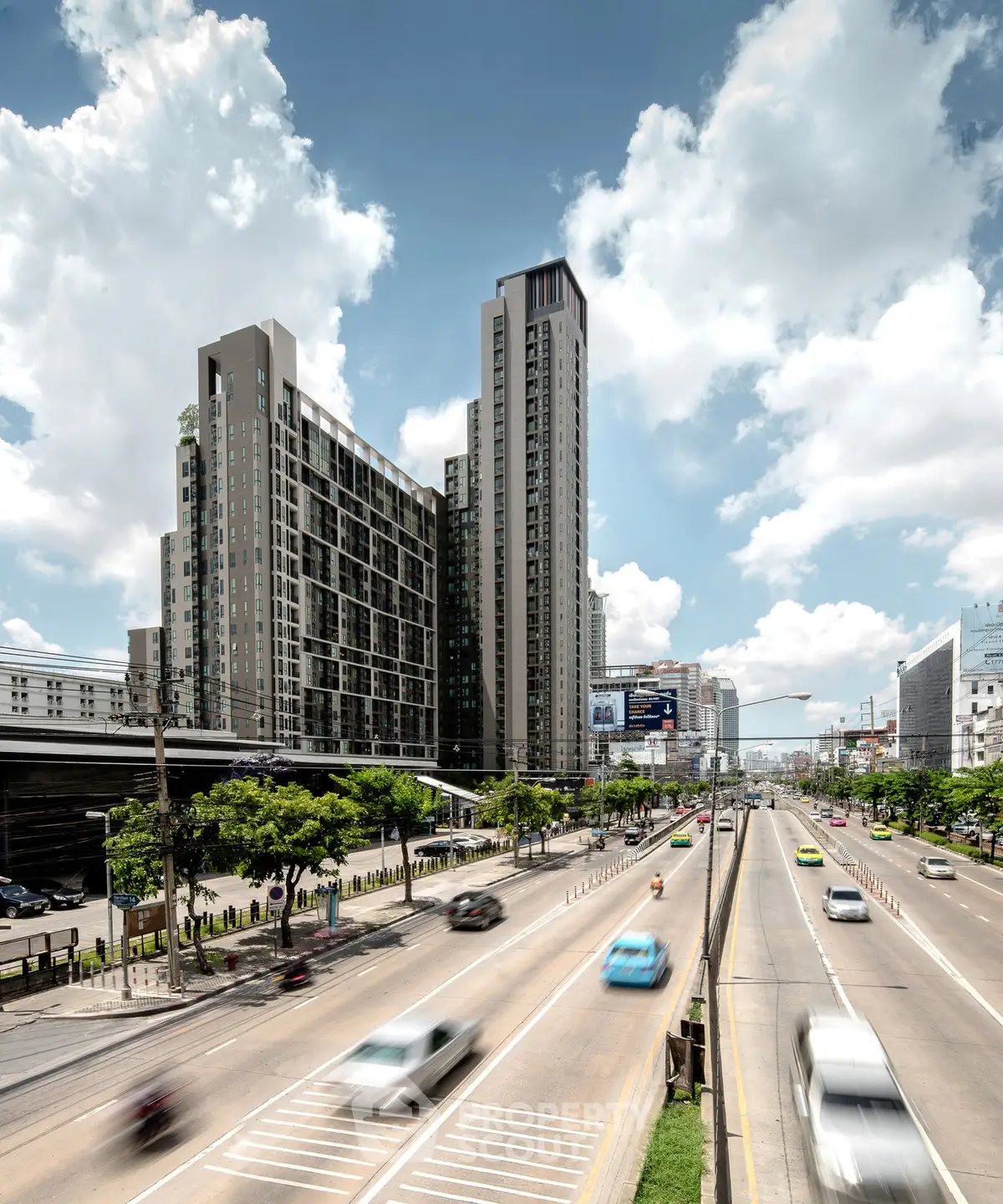 Modern high-rise building with urban road view under a clear sky