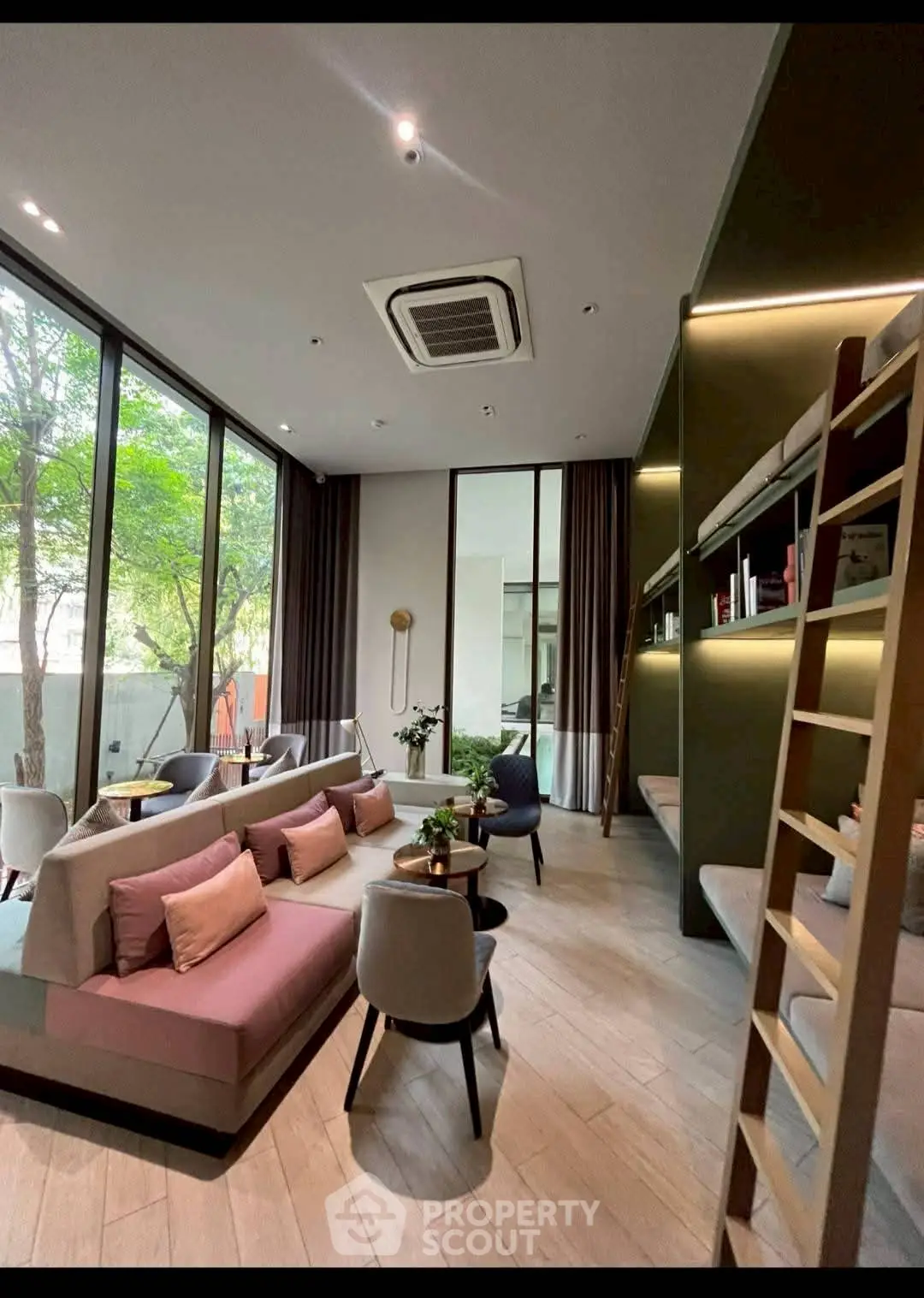 Modern living room with high ceilings, large windows, and stylish furniture in a contemporary setting.