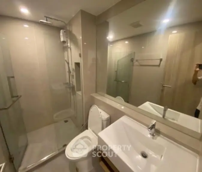 Modern bathroom with glass shower and sleek fixtures