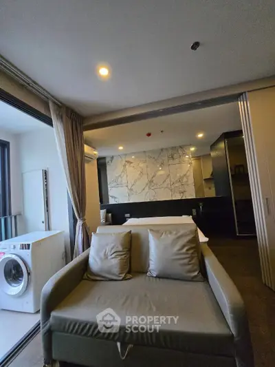 Modern living room with sleek design and washing machine on balcony