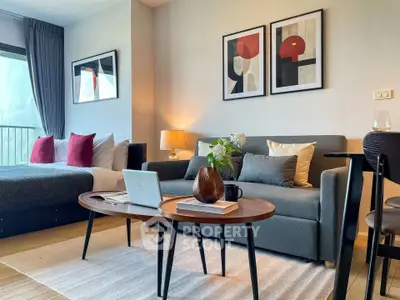 Modern studio apartment with stylish decor, featuring a cozy living area and a comfortable bed.