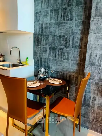 Modern kitchen with dining area featuring sleek design and contemporary furniture.