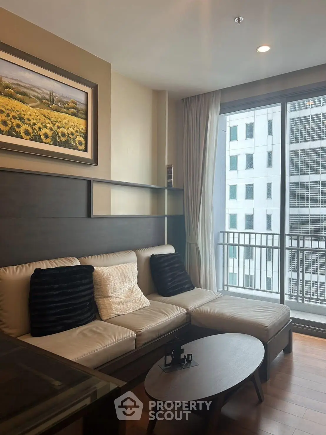 Modern living room with cozy sofa and city view through large window