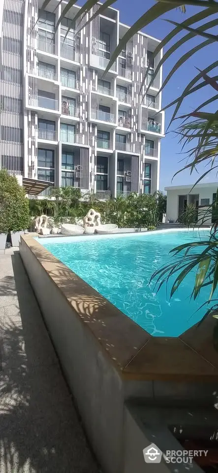 Luxurious apartment building with stunning pool and lush greenery