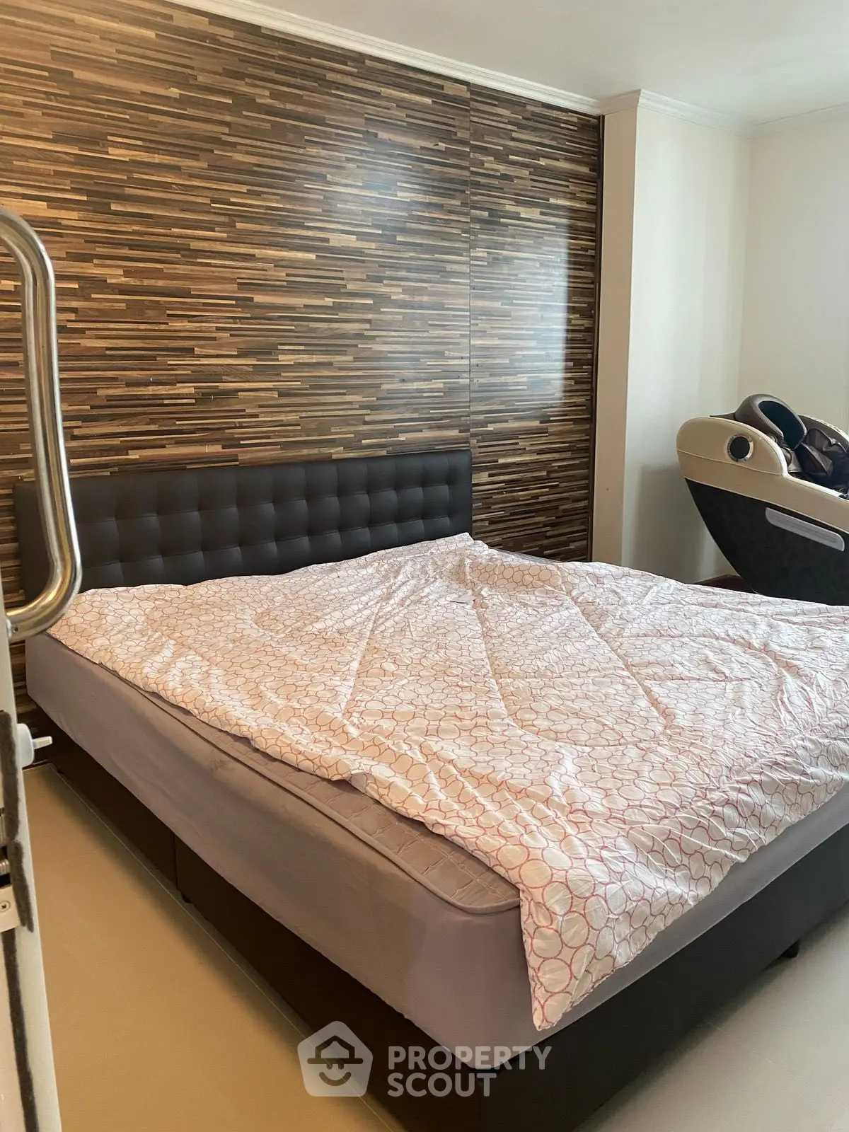 Modern bedroom with stylish wood accent wall and cozy bedding