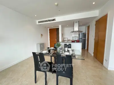 Modern open-plan kitchen and dining area with sleek design and contemporary furniture.