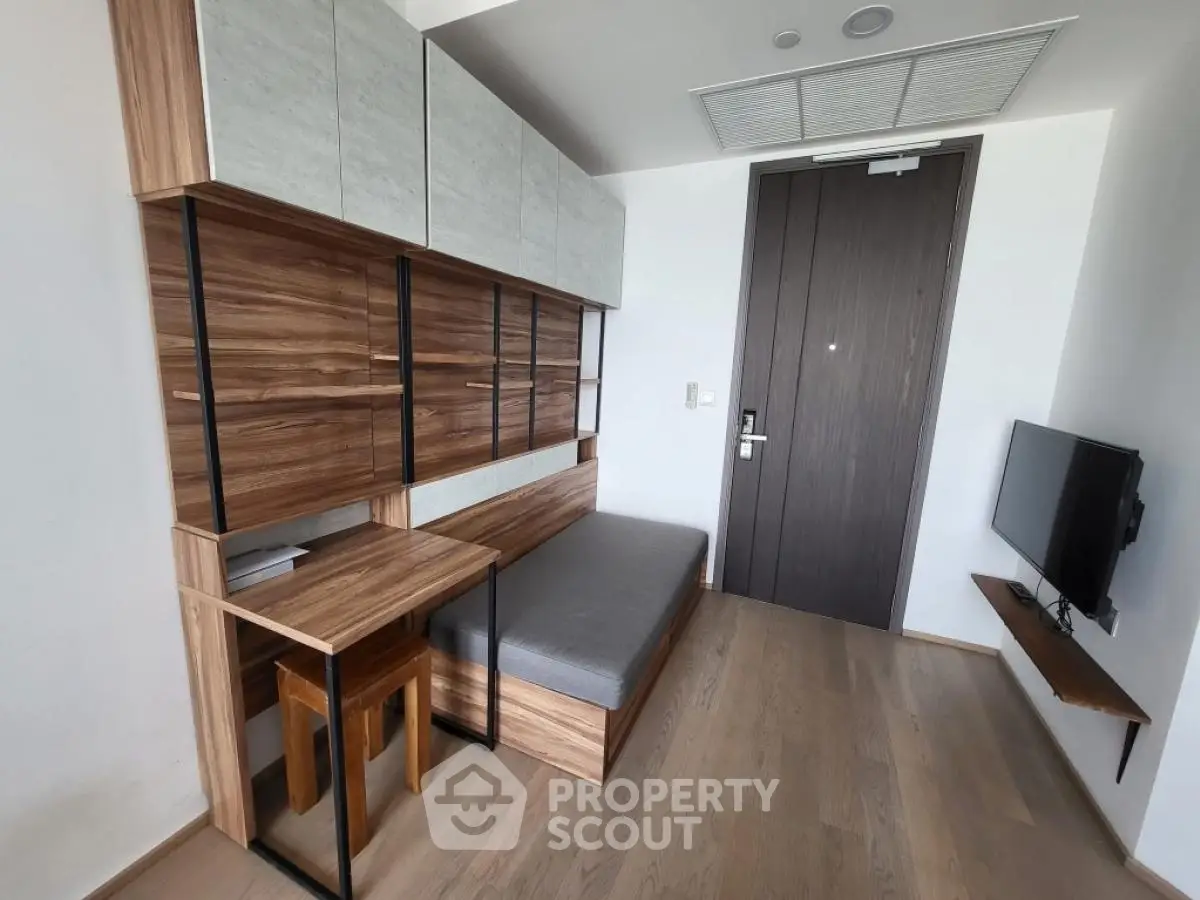Modern compact living space with stylish wooden furniture and wall-mounted TV