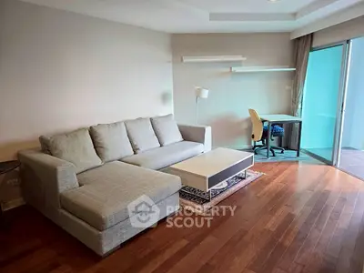 Modern living room with cozy gray sofa and sleek wooden flooring