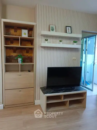 Modern living room with stylish wooden furniture and wall-mounted shelves, featuring a sleek TV setup.