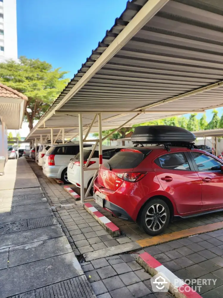 Covered parking area with multiple cars in a residential complex