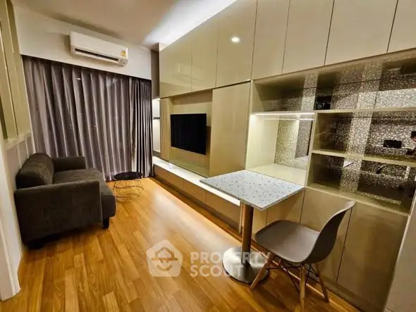 Modern living room with sleek furniture and wooden flooring, featuring a cozy sofa and stylish dining area.
