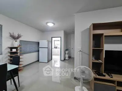 Modern living area with sleek furniture and open kitchen layout