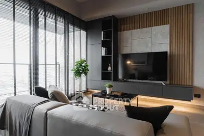 Luxurious living room with modern design, sleek furniture, and large windows offering ample natural light and a serene view, perfect for upscale urban living.