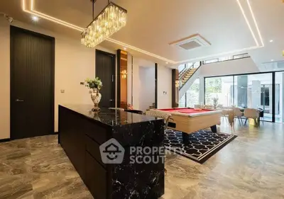 Luxurious open-plan living area with pool table and modern decor