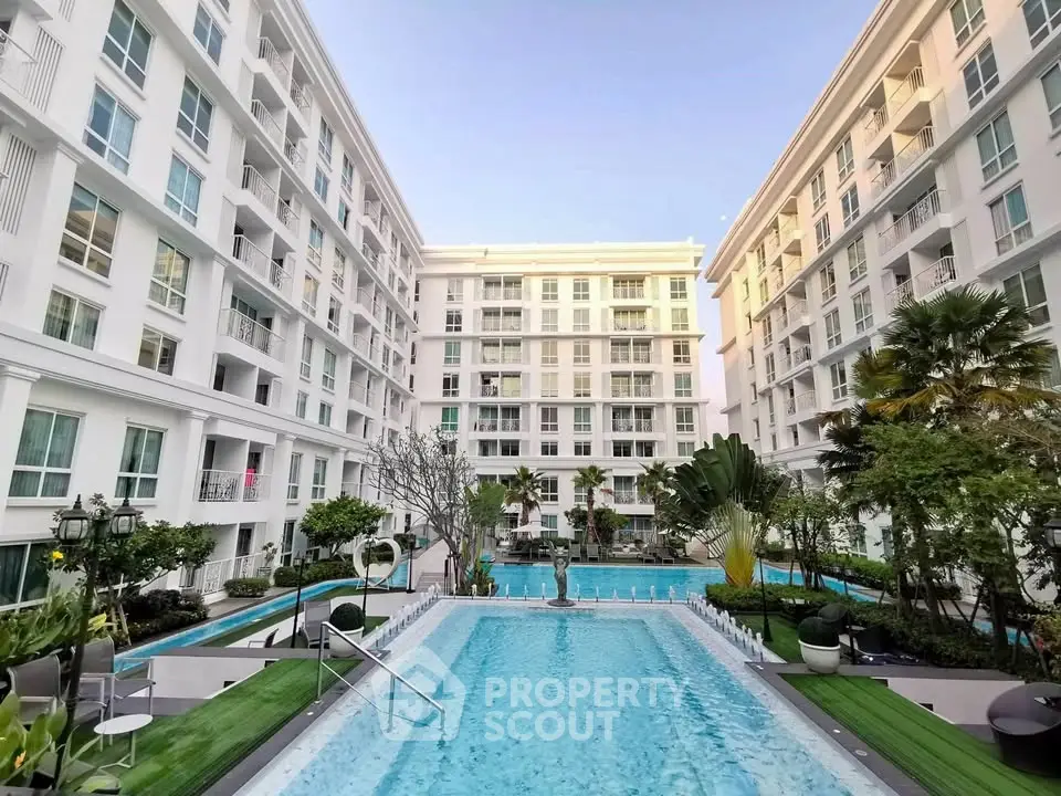 Luxurious apartment complex with stunning pool and lush gardens, perfect for modern living.