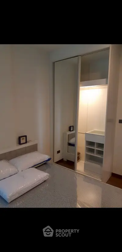 Modern bedroom with mirrored closet and cozy bedding