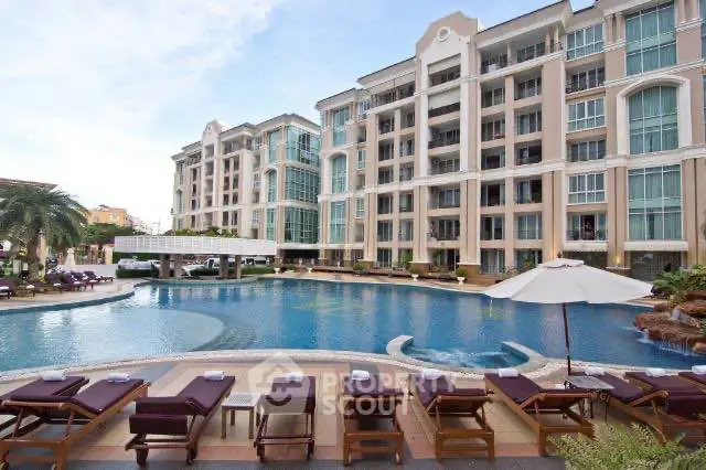 Luxurious apartment complex with stunning pool and modern architecture.